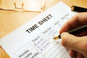 Hand Writing in times on an employee time sheet